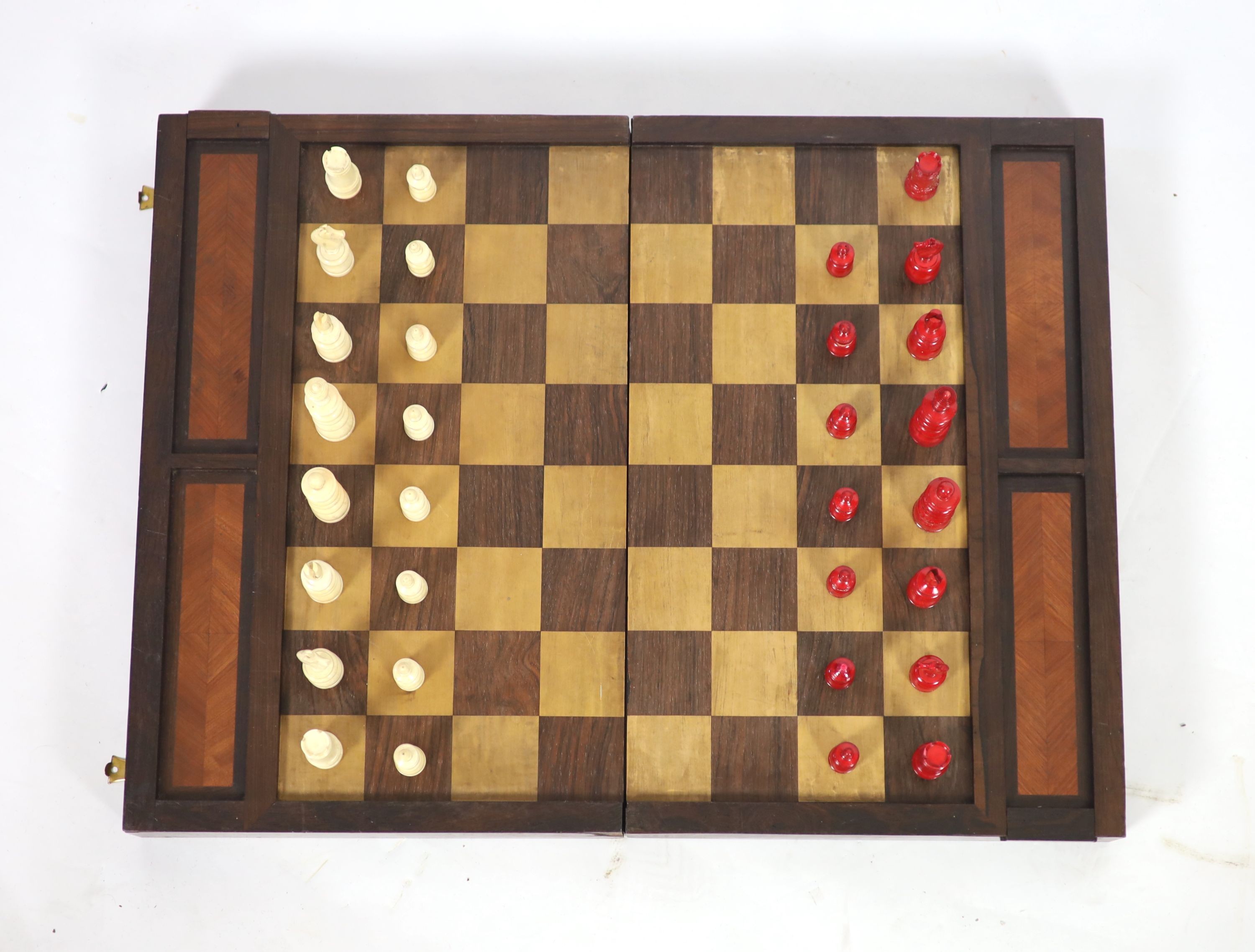 An early 20th century rosewood folding games board, external chess and internal backgammon, W 75cm D 56cm when open, W 75cm D 37cm when closed